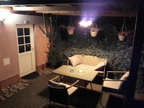 a patio with a table and chairs and a wall with plants at Ranch 79 in Smědčice