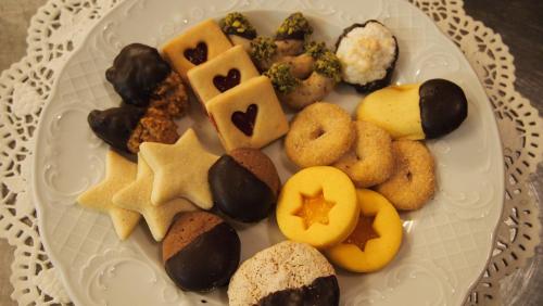 a plate of cookies and other food on a table at Hotel Reichegger in Villa Ottone