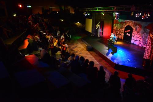 a crowd of people watching a man on a stage at Pantelleria Resort in Pantelleria