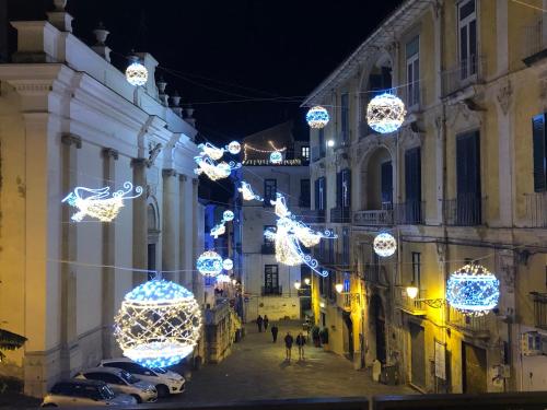 a street with christmas lights in a city at night at La dimora del barone in Salerno
