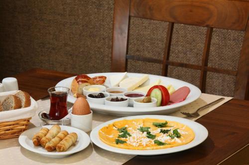 コジャエリにあるBalturk House Hotelの食べ物の皿が2枚置かれたテーブル