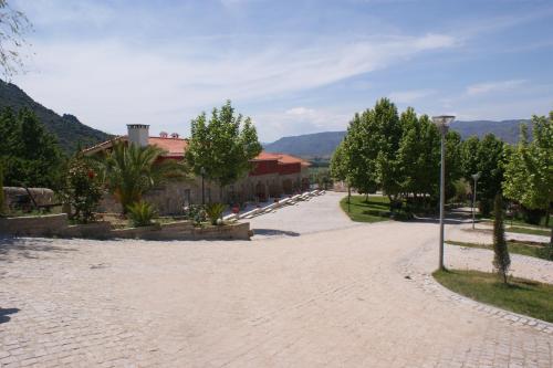 a cobblestone street with trees and a building at Quinta da Terrincha in Torre de Moncorvo