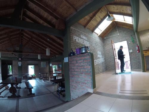 a man standing in the middle of a building at Hostel Los Pioneros in El Calafate