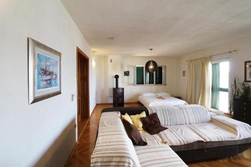 a living room with two beds and a couch at House Lipo in Makarska
