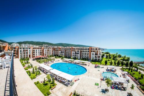 an aerial view of a resort with a swimming pool and the ocean at Prestige Mer d'Azur in Sunny Beach