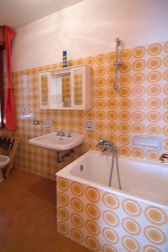 a bathroom with a sink and a bath tub at Camping Hotel Au Lac De Como in Sorico