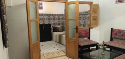 a small room with a door and a bed at Dar HAJAR in Marrakech