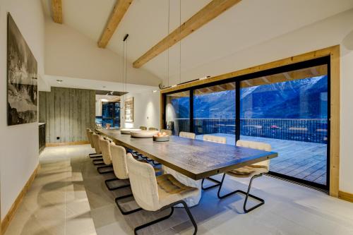 a dining room with a large table and chairs at Le Chalet Mont Blanc in Les Houches