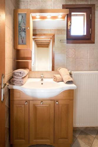 a bathroom with a sink and a mirror at Armamento Villa in Skiathos