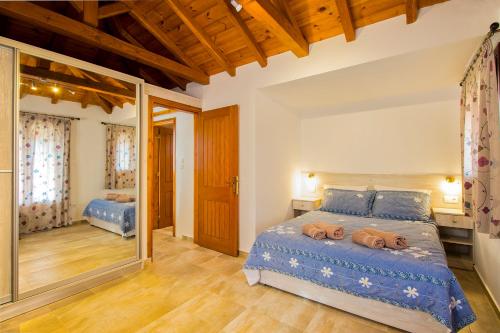 a bedroom with a bed with two towels on it at Armamento Villa in Skiathos