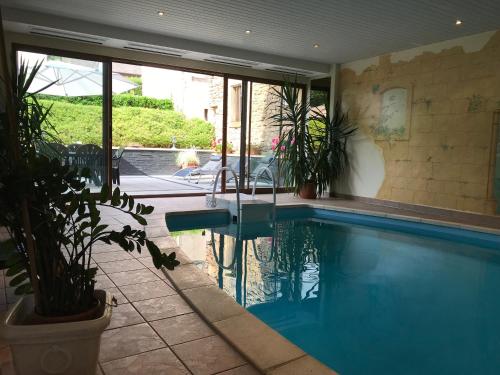a large swimming pool in a house with at Les Berges de l'Ohmbach in Soultzmatt