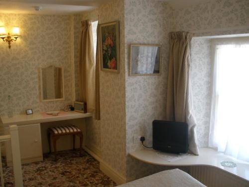 Postel nebo postele na pokoji v ubytování Lastingham Grange