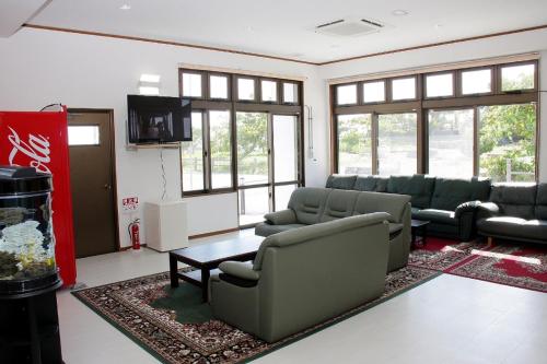 a living room with couches and a table at Hotel Tulip Ishigakijima in Ishigaki Island