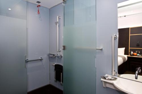 a bathroom with a shower and a sink at The Z Hotel Covent Garden in London