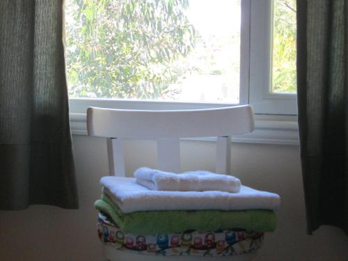 a white chair sitting in front of a window at La Casa de Liber in Tandil