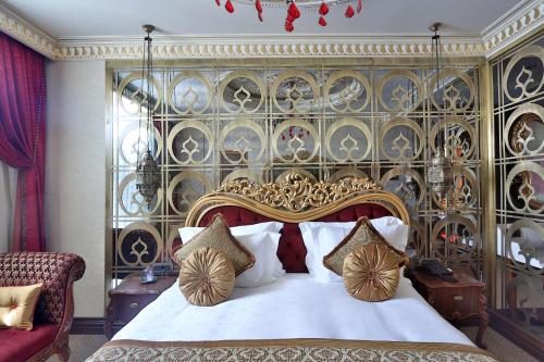 a bedroom with a large bed with a large headboard at Daru Sultan Hotels Galata in Istanbul