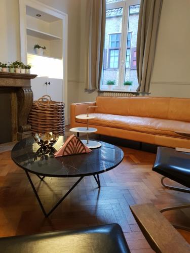 a living room with a couch and a table at Homey - Kortrijk in Kortrijk