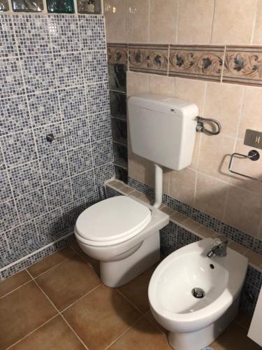 a bathroom with a white toilet and a sink at Locanda Beatrice in Sanremo