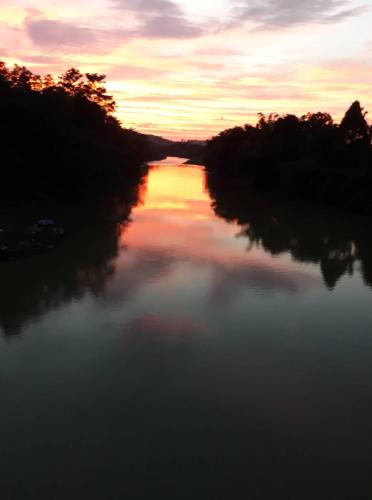 a view of a river at sunset at Gibbon Singing Home Stay in Quan Tom