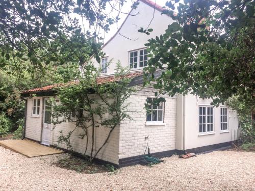 a small white house with a yard at The Broken Dish - Full Cottage Apartment in Mendham