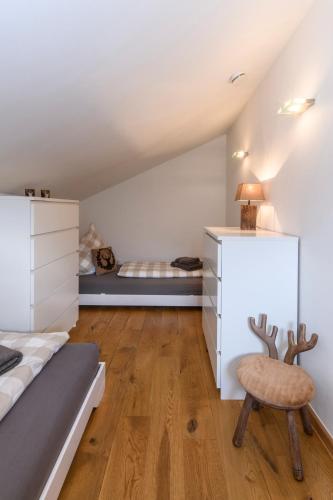 a bedroom with a bed and a desk and a chair at Chalet "Altes Schulhaus" in Schruns-Tschagguns