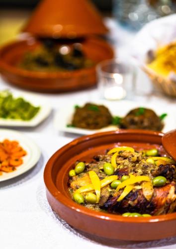 a bowl of food with peas and cheese on a table at Riad Leila Marrakech in Marrakech