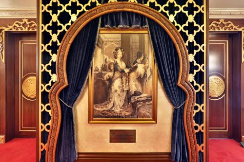a framed painting of a woman on a wall at Daru Sultan Hotels Galata in Istanbul