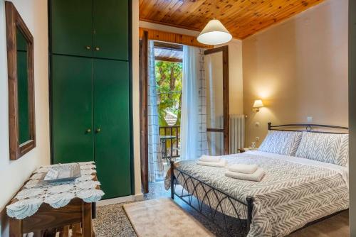 a bedroom with a large bed and a green closet at Helidona in Mikrón Khoríon