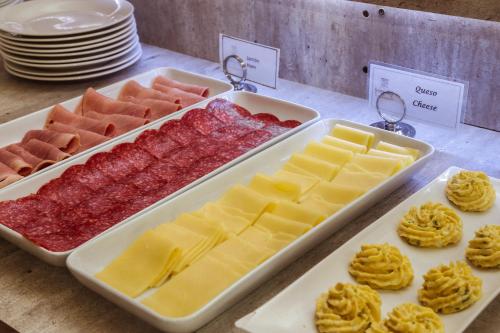a display of different types of cheeses and other foods at Easter Island Ecolodge in Hanga Roa