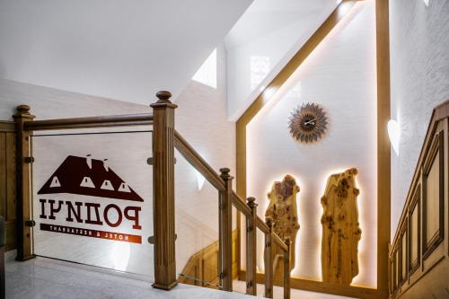 a staircase in a house with a sign on the wall at Родичі in Zhashkiv