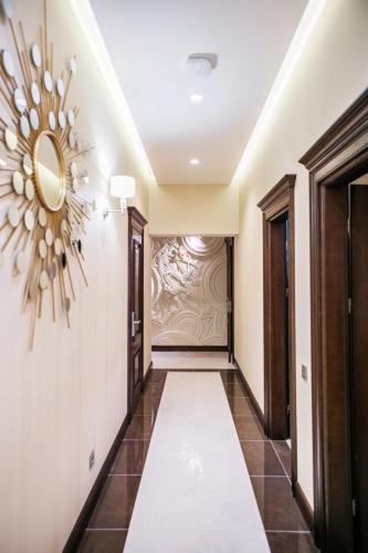 a hallway with a large clock on the wall at Родичі in Zhashkiv