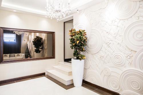 a lobby with stairs and a large wall mural at Родичі in Zhashkiv