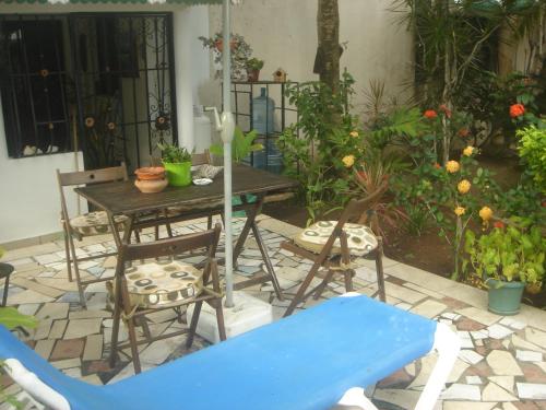 a patio with a table and chairs and a blue bench at Dre Broeders Apartments Juan Dolio in Juan Dolio