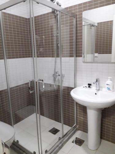 a bathroom with a shower and a sink at Hotel Old Konak in Skopje