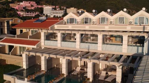 an aerial view of a building with a swimming pool at Agios Gordios Beach Resort in Agios Gordios