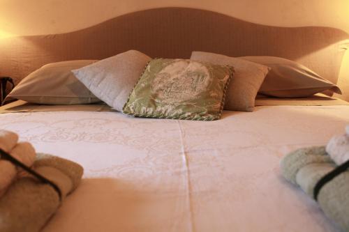 a close up of a bed with pillows on it at B&B Casa Meli in Cadepiaggio