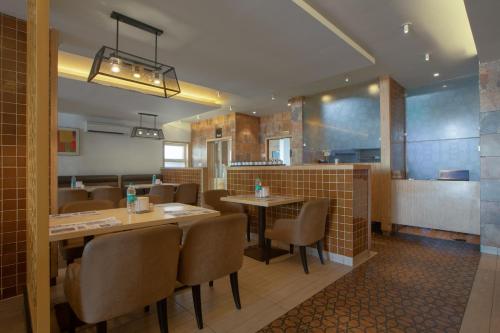 un restaurante con mesas y sillas en una habitación en Hotel Vashanth Krishna en Nāgercoil