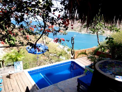 a swimming pool with a view of the water at Hostal Casa Horizonte in Taganga