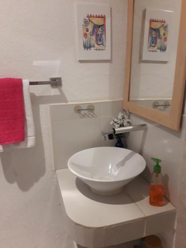 a bathroom with a white sink and a mirror at Casa Luz Verde in Cancún