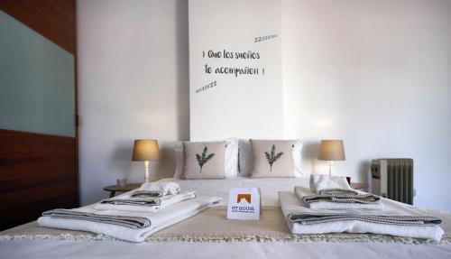 a bedroom with a bed with towels on it at Amadora Terrace View in Amadora