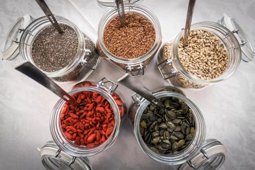 a group of four jars filled with different types of food at Hotel Oasi Beach in Malcesine