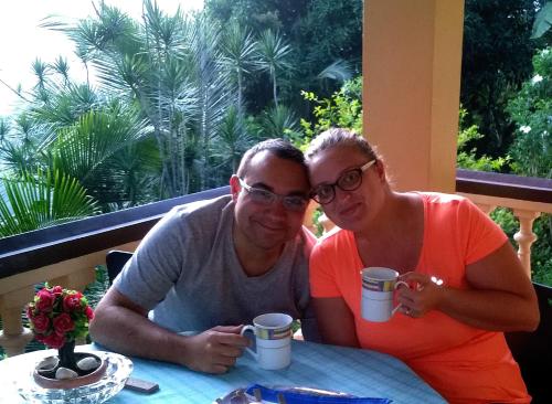 a man and a woman sitting at a table with cups at Evergreen in Kandy