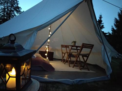 a tent with a table and chairs and a lamp at Trapani house & camp in Růžová