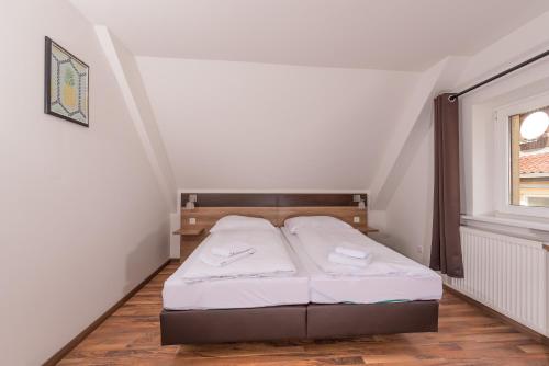a small bedroom with a bed in a attic at Boutique-Hotel Kronenstuben in Ludwigsburg