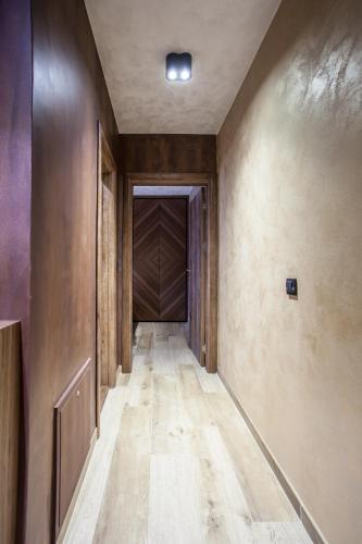 an empty hallway with wood floors and a ceiling at Bella Roe Premium Apartments in Belgrade