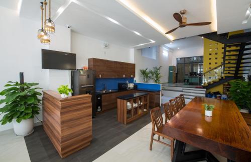 a kitchen with wooden furniture and a dining room at La An Homestay in Hoi An