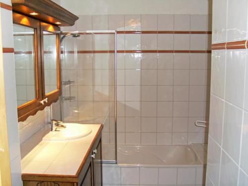 a bathroom with a shower and a sink and a tub at Spacious Apartment 2 Minutes from Ski Lift, Equipped for Babies in Les Houches