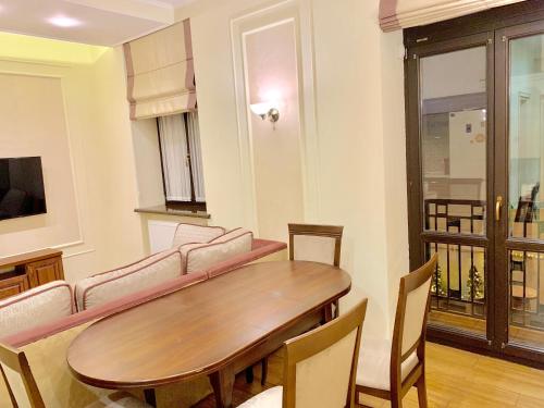 een woonkamer met een tafel en een bank bij Two-bedroom on Lesi Ukrainky in Lviv