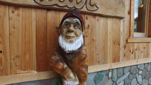 a statue of a monkey is attached to a wall at Dolomiti Village in Comeglians