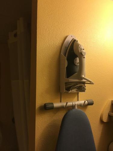 a helmet and a baseball bat on a wall at Days Inn by Wyndham Scranton PA in Dickson City